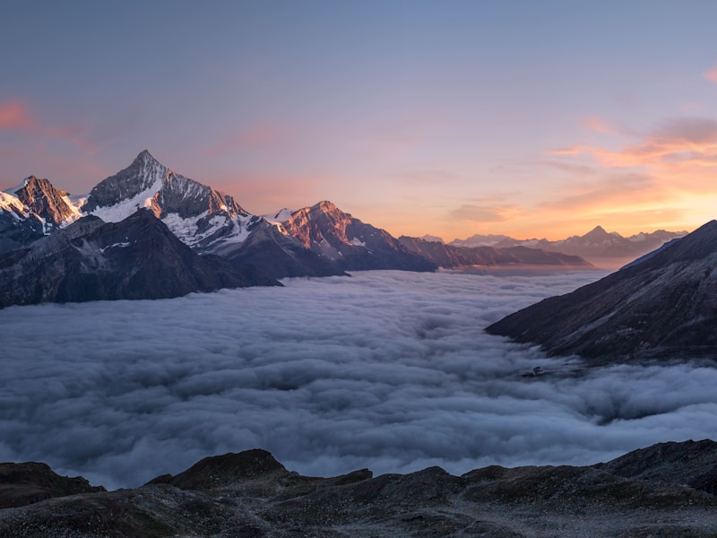 Cross silhouette against mountain sunrise